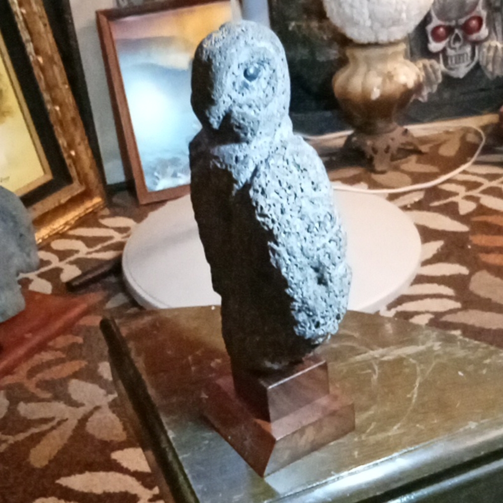 Hand carved stone bird on KOA stand